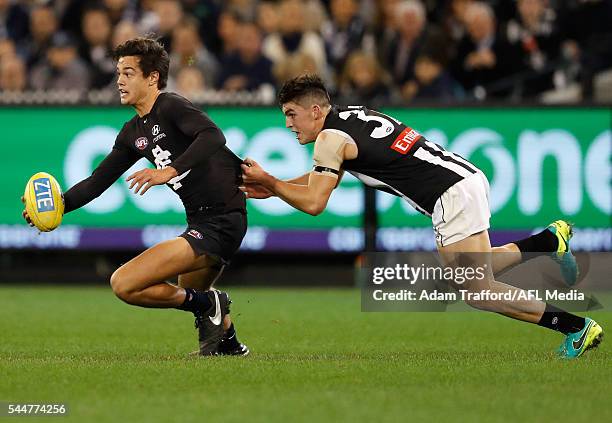 Jack Silvagni of the Blues is tackled by Brayden Maynard of the Magpies during the 2016 AFL Round 15 match between the Carlton Blues and the...