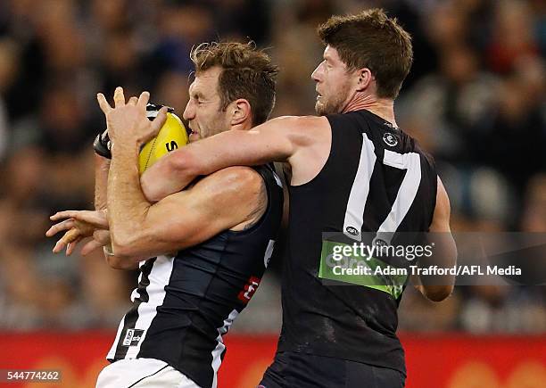 Travis Cloke of the Magpies and Sam Rowe of the Blues during the 2016 AFL Round 15 match between the Carlton Blues and the Collingwood Magpies at the...