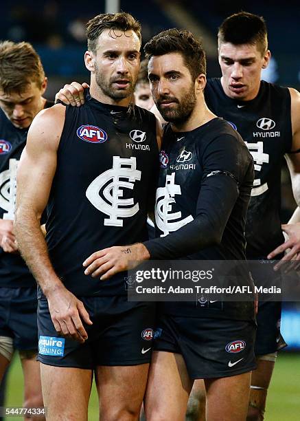 Kade Simpson of the Blues consoles Andrew Walker of the Blues after his 200th game during the 2016 AFL Round 15 match between the Carlton Blues and...