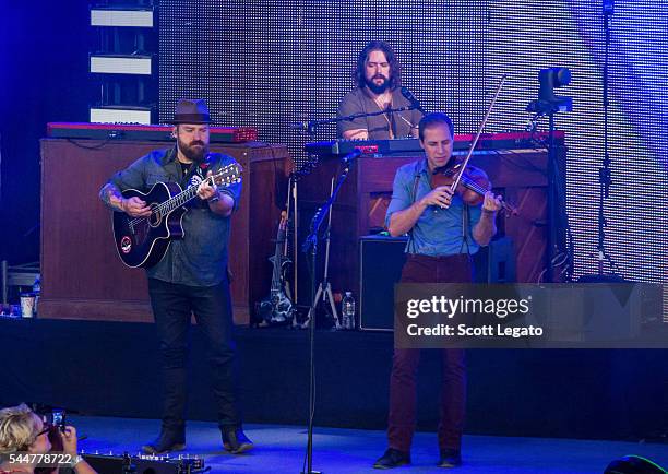 Zac Brown, Clay Cook and Coy Bowles of the Zac Brown band perform during the Black Out The Sun Tour at DTE Energy Music Theater on July 2, 2016 in...