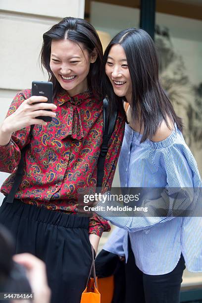 Sun Jung Lee and Ji Hye Park take a photo at the Hermes presentation on July 3, 2016 in Paris, France.