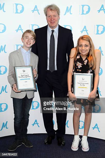 Earl Spencer presents Ryan Wiggins and Katie Kryzanowski with the Diana Award during a photocall at Barclays, Churchill Place on July 4, 2016 in...