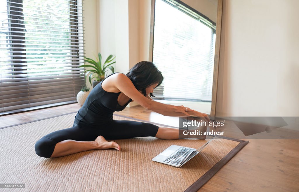 Asian woman doing yoga at home