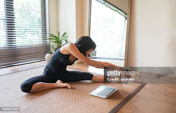 asian woman doing yoga at home - one woman only videos stock pictures, royalty-free photos & images