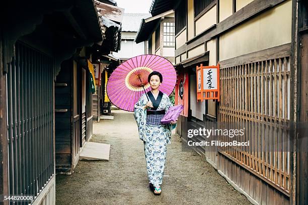 japanese woman in traditional clothes walking in kyoto - red parasol stock pictures, royalty-free photos & images