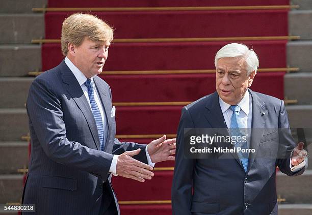 King Willem-Alexander leads Greek President Prokopis Pavlopoulos to review the guard of honour at the Noordeinde Palace at the start of a two-day...