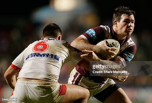 Jamie Lyon of the Sea Eagles is tackled by Gareth Widdop of the Dragons during the round 17 NRL match between the Manly Sea Eagles and the St George...