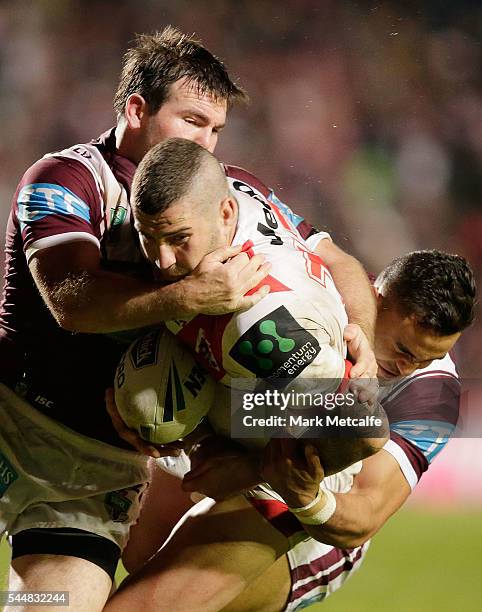 Joel Thompson of the Dragons is tackled during the round 17 NRL match between the Manly Sea Eagles and the St George Illawarra Dragons at Brookvale...