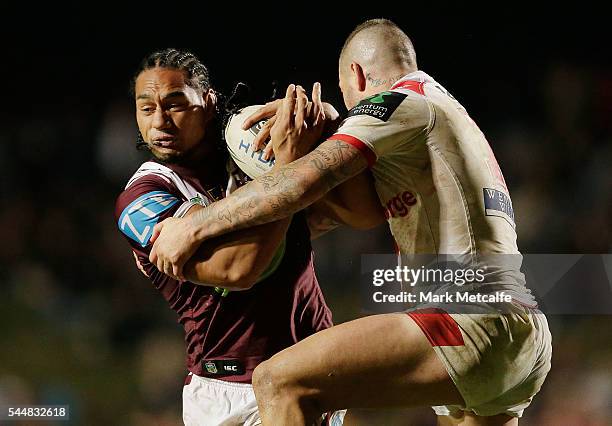 Martin Taupau of the Sea Eagles is tackled by Joel Thompson of the Dragons during the round 17 NRL match between the Manly Sea Eagles and the St...