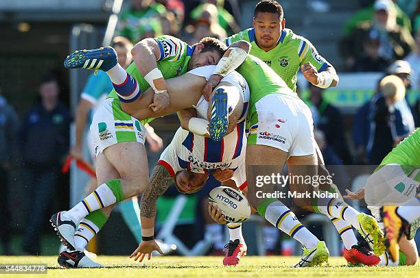 Korbin Sims of the Knights is up ended in a tackle during the round 17 NRL match between the Canberra Raiders and the Newcastle Knights at GIO...