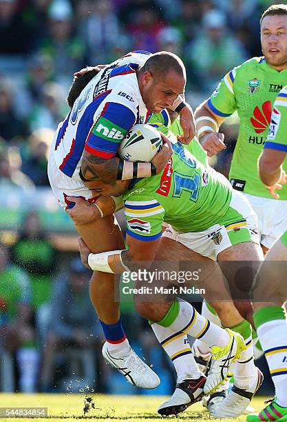 Jeremy Smith of the Knights is tackled during the round 17 NRL match between the Canberra Raiders and the Newcastle Knights at GIO Stadium on July 3,...