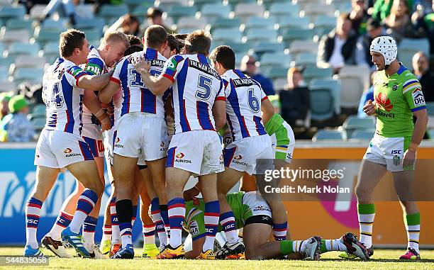 Knights players celebrate a try by Jake Mamo during the round 17 NRL match between the Canberra Raiders and the Newcastle Knights at GIO Stadium on...