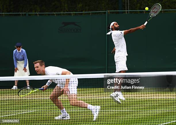 Adil Shamasdin of Canade and Jonathan Marray of Great Britain in action during the Men's Doubles first round match against Pablo Cuevas of Uraguay...