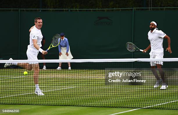 Adil Shamasdin of Canade and Jonathan Marray of Great Britain in action during the Men's Doubles first round match against Pablo Cuevas of Uraguay...