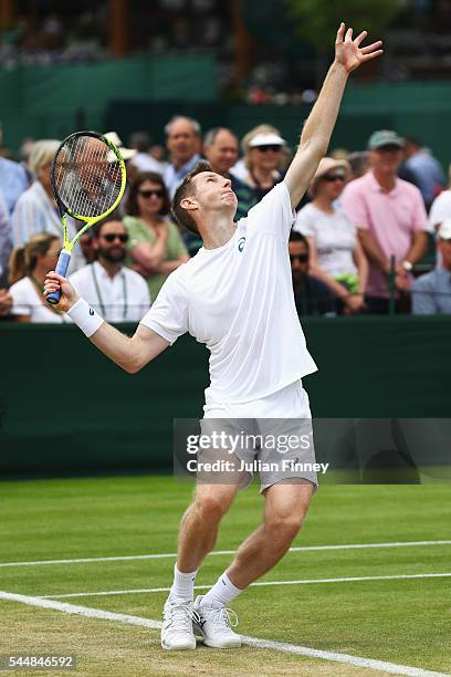 Jonathan Marray of Great Britain serves during the Men's Doubles first round match against Pablo Cuevas of Uraguay and Marcel Granollers of Spain on...