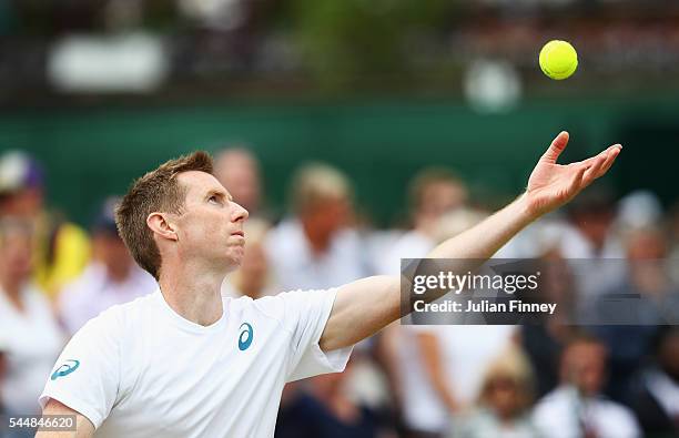 Jonathan Marray of Great Britain serves during the Men's Doubles first round match against Pablo Cuevas of Uraguay and Marcel Granollers of Spain on...