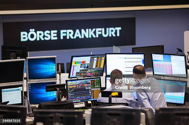 Financial traders monitor data on computer screens inside the Frankfurt Stock Exchange in Frankfurt, Germany, on Monday, July 4, 2016. London Stock...