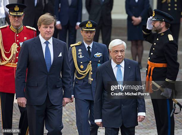 Greek President Prokopis Pavlopoulos and King Willem-Alexander review the guard of honour at the Noordeinde Palace at the start of a two-day visit on...