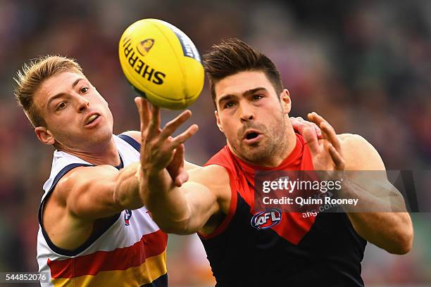 Chris Dawes of the Demons attempts to mark infront of Daniel Talia of the Crows during the round 15 AFL match between the Melbourne Demons and the...