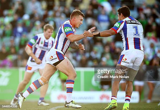Trent Hodkinson of the Knights celebrates kicking a field goal during the round 17 NRL match between the Canberra Raiders and the Newcastle Knights...