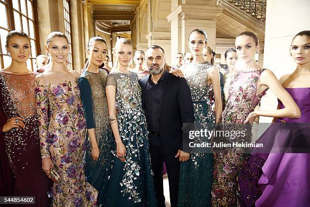 Georges Hobeika poses with models backstage during the Georges Hobeika Haute Couture Fall/Winter 2016-2017 show as part of Paris Fashion Week on at...