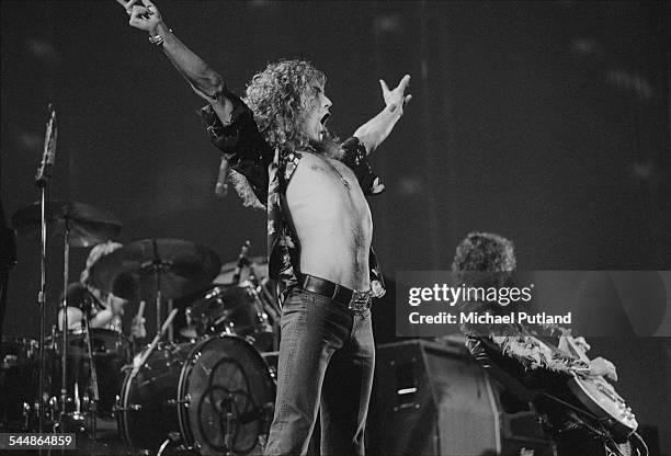 Robert Plant and Jimmy Page performing with British heavy rock group Led Zeppelin, at Earl's Court, London, May 1975. John Bonham is behind the kit ....