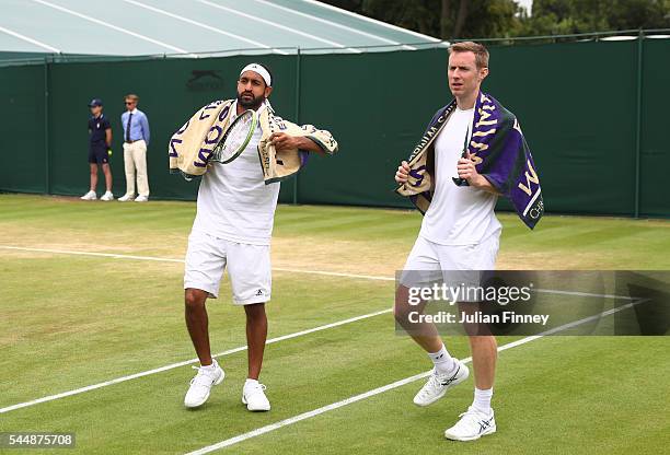 Adil Shamasdin of Canada and Jonathan Marray of Great Britain look on during the Men's Doubles first round match against Pablo Cuevas of Uraguay and...