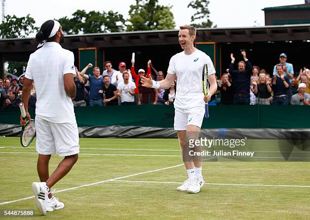 Adil Shamasdin of Canada and Jonathan Marray of Great Britain celebrates victory during the Men's Doubles first round match against Pablo Cuevas of...