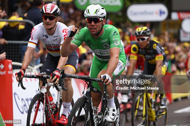 Mark Cavendish of Great Britain and Team Dimension Data celebrates the stage win from Andre Greipel of Germany and Lotto Soudal during stage three of...