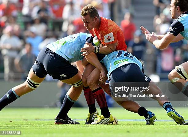 Riaan Viljoen of Sunwolves is tackled during the Super Rugby round 15 match between the Sunwolves and the Waratahs at Prince Chichibu Stadium on July...