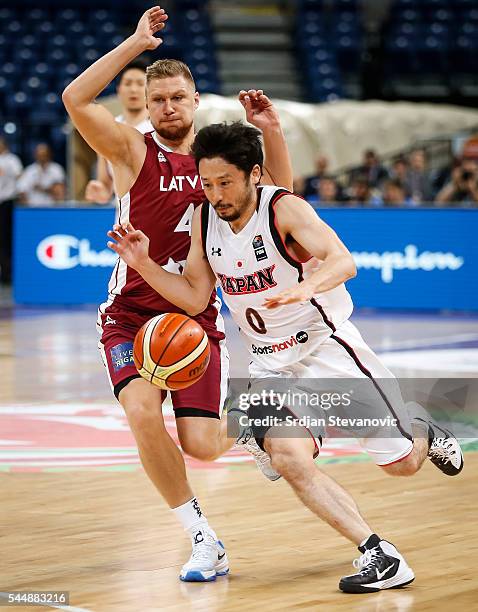 Yuta Tabuse of Japan in action against Ingus Jakovics of Latvia during the 2016 FIBA World Olympic Qualifying basketball Group A match between Japan...