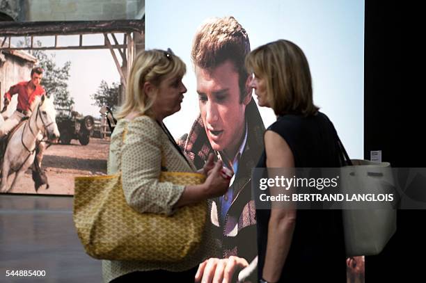 People visit the exhibition "Western Camarguais" as part of the photography festival "Rencontres de la photographie d'Arles 2016" in Arles, southern...