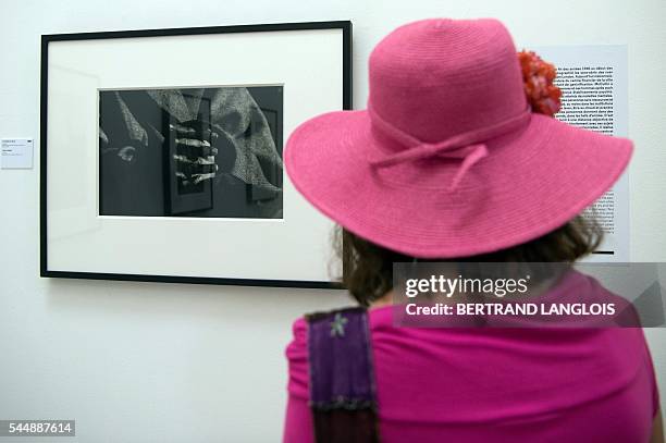 Woman visits the exhibition "Looking beyond the edge" by Don McCullin as part of the photography festival "Rencontres de la photographie d'Arles...
