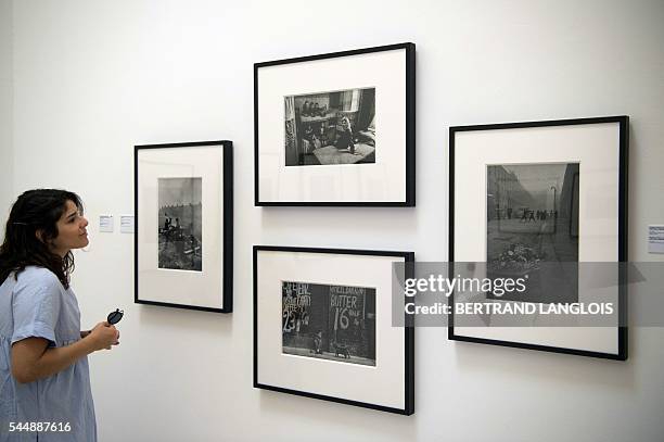 Woman visits the exhibition "Looking beyond the edge" by Don McCullin as part of the photography festival "Rencontres de la photographie d'Arles...