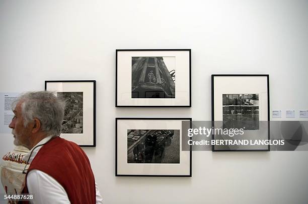 People visit the exhibition "Looking beyond the edge" by Don McCullin as part of the photography festival "Rencontres de la photographie d'Arles...