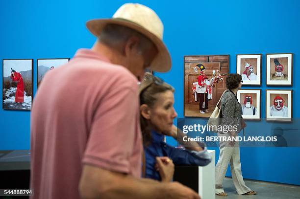 People visit the exhibition "Yokainoshima" by Charles Freger as part of the photography festival "Rencontres de la photographie d'Arles 2016" in...