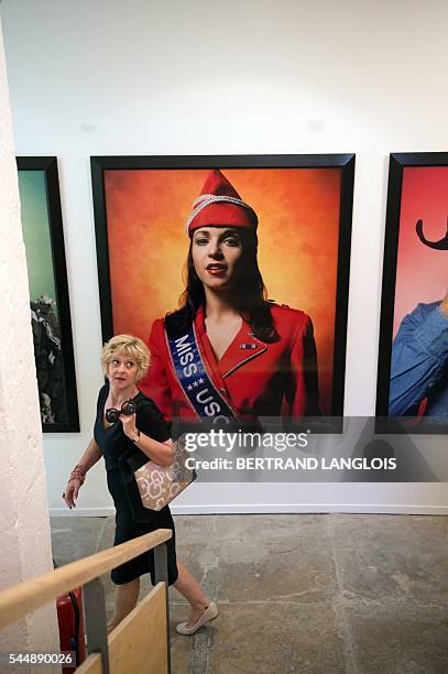 Woman reacts as she visits the exhibition by Andres Serrano as part of the photography festival "Rencontres de la photographie d'Arles 2016" in...