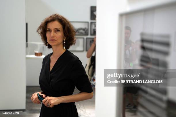French Culture Minister Audrey Azoulay reacts as she visits the exhibition "A history of misogyny, chapter one : on abortion" by Laia Abril as part...