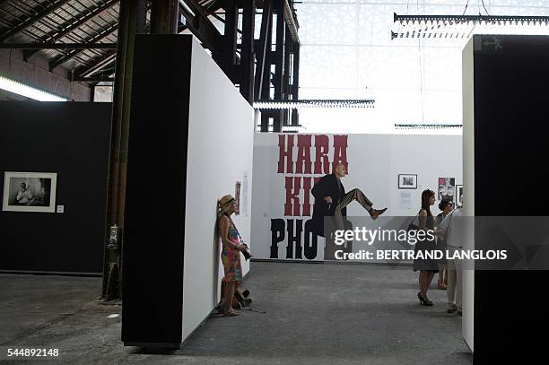 People visit the exhibition "Hara Kiri Photo" as part of the photography festival "Rencontres de la photographie d'Arles 2016" in Arles, southern...