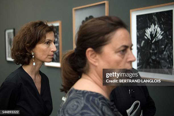 French Culture Minister Audrey Azoulay and Swiss art patron and founder of the LUMA foundation Maja Hoffmann visit the exhibition by Zanele Muholi as...