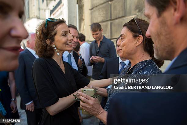 French Culture Minister Audrey Azoulay speaks with Swiss art patron and founder of the LUMA foundation Maja Hoffmann as they visit the photography...