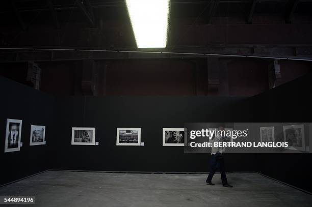 Man visits an exhibition as part of the photography festival "Rencontres de la photographie d'Arles 2016" in Arles, southern France, on July 4, 2016....