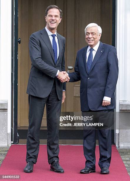 Dutch Prime Minister Mark Rutte greets Greek President Prokopis Pavlopoulos upon his arrival at the Catshuis residence in The Hague, on July 4, 2016....