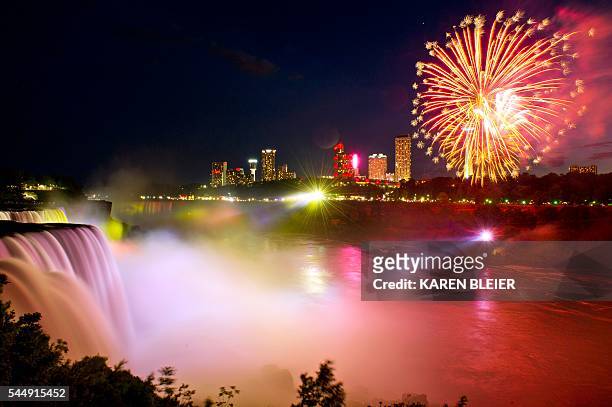 Fireworks set off from the Canadian side light up the sky over Niagra Falls late July 3 part of the July 4th US Independence Day celebrations, in...