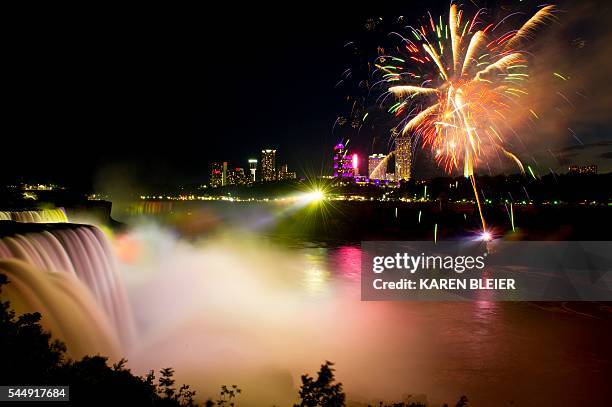 Fireworks set off from the Canadian side light up the sky over Niagra Falls late July 3 part of the July 4th US Independence Day celebrations, in...