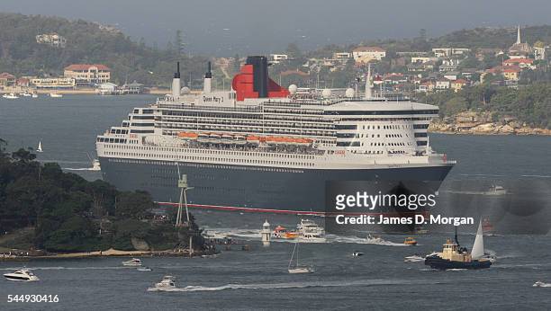 Crowds on the shore and boats on the water greet Queen Mary 2 on March 7, 2010 in Sydney, Australia. The largest ship to ever visit Australia,...
