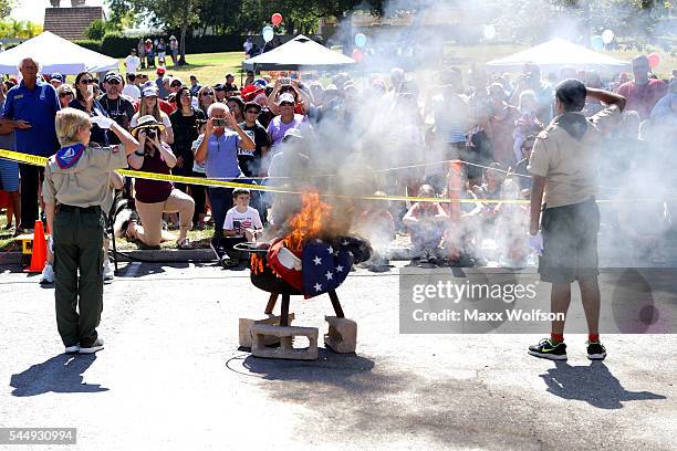 Scouts from Boy Scouts of America's Troop 775 retire a worn American flag during a ceremony before the start of the 47th Annual Westlake Village 4th...