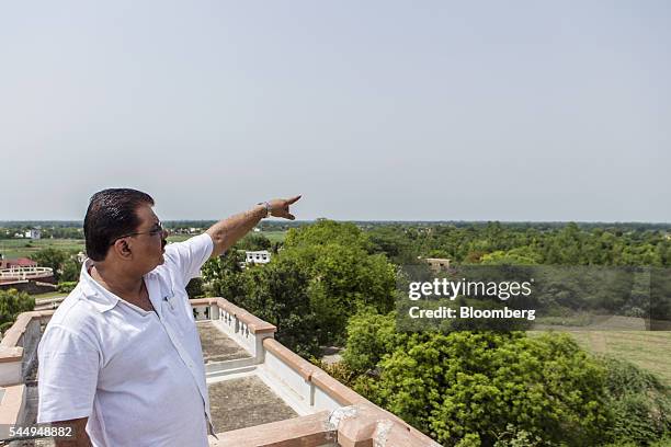 Landowner Kunwar Vikram Jeet Singh gestures towards his farmland from the roof of his mansion in Kuchesar, Uttar Pradesh, India, on Tuesday, May 24,...