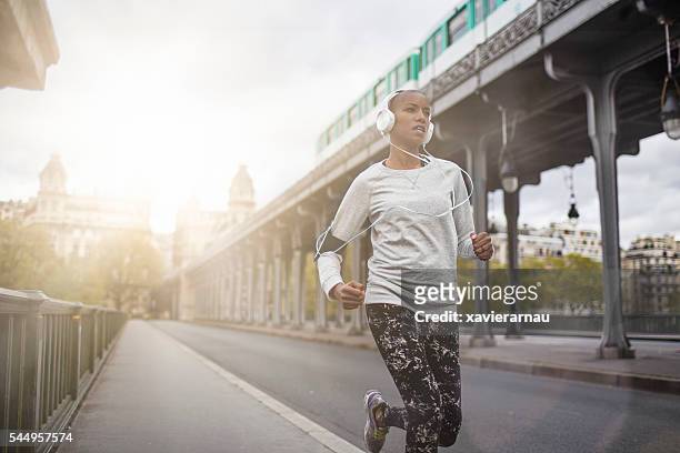 woman running in paris - paris sport stock pictures, royalty-free photos & images