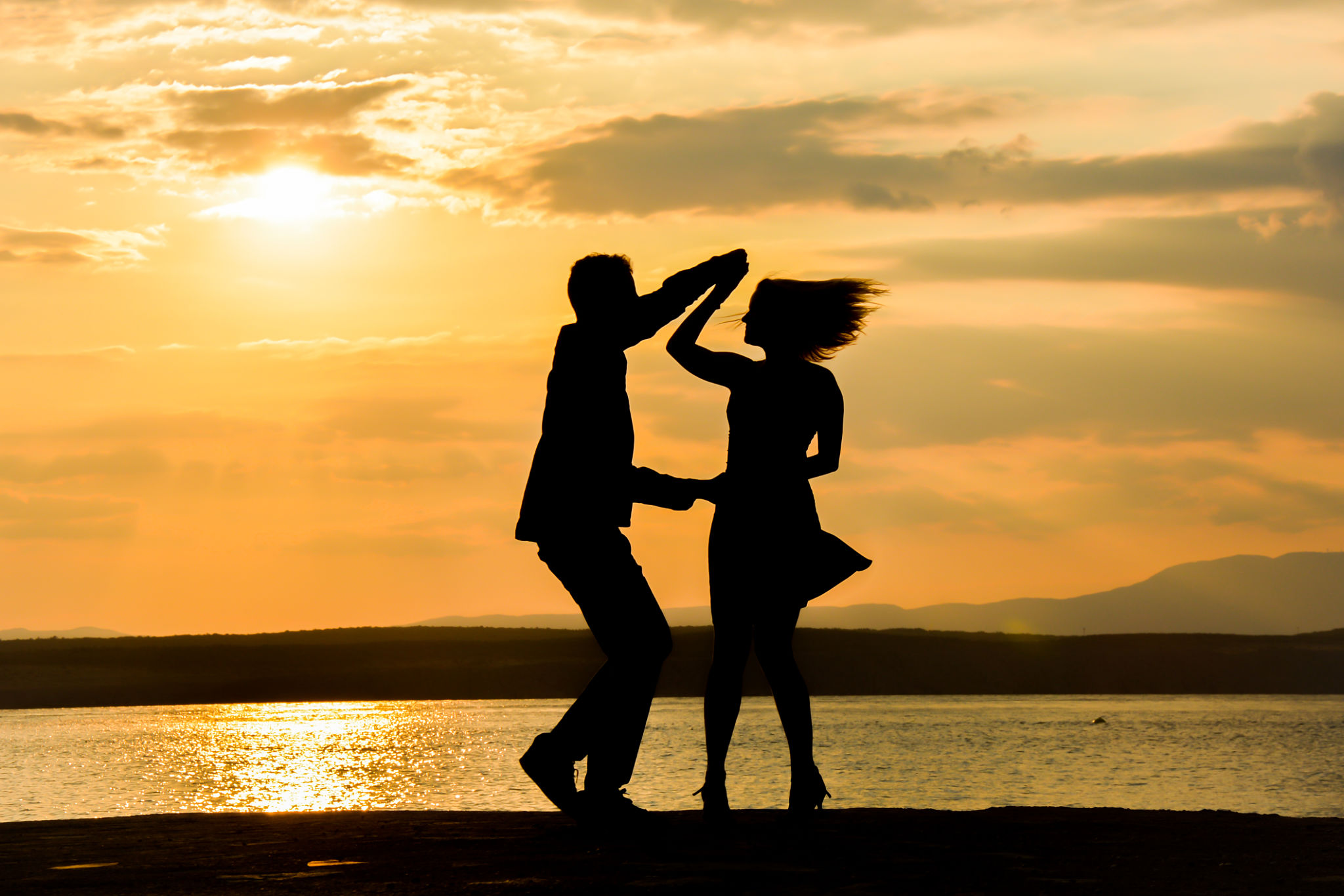 Couple dancing salsa at sunset Couple dancing salsa at sunset
